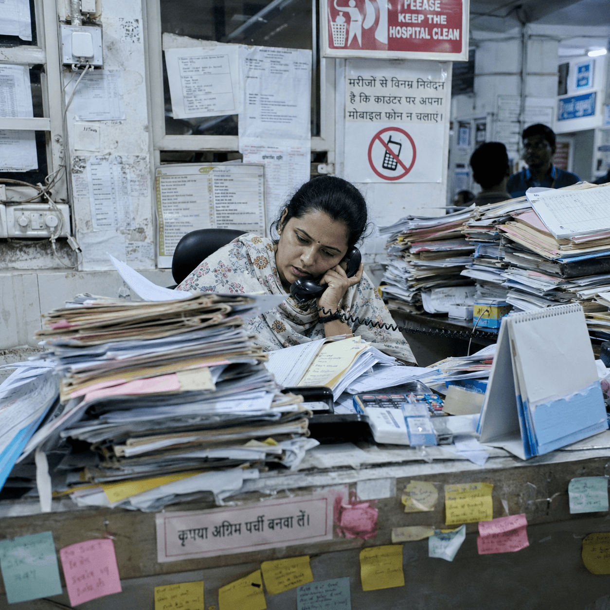 Hospital owner reviewing stacks of paper trying to find revenue leakage